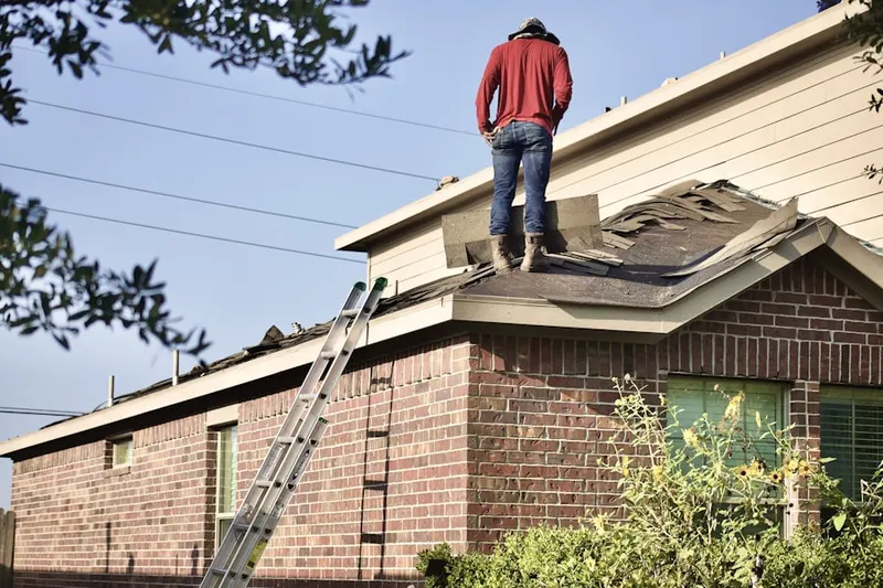 Professional roofer working on a residential roof in Sproul